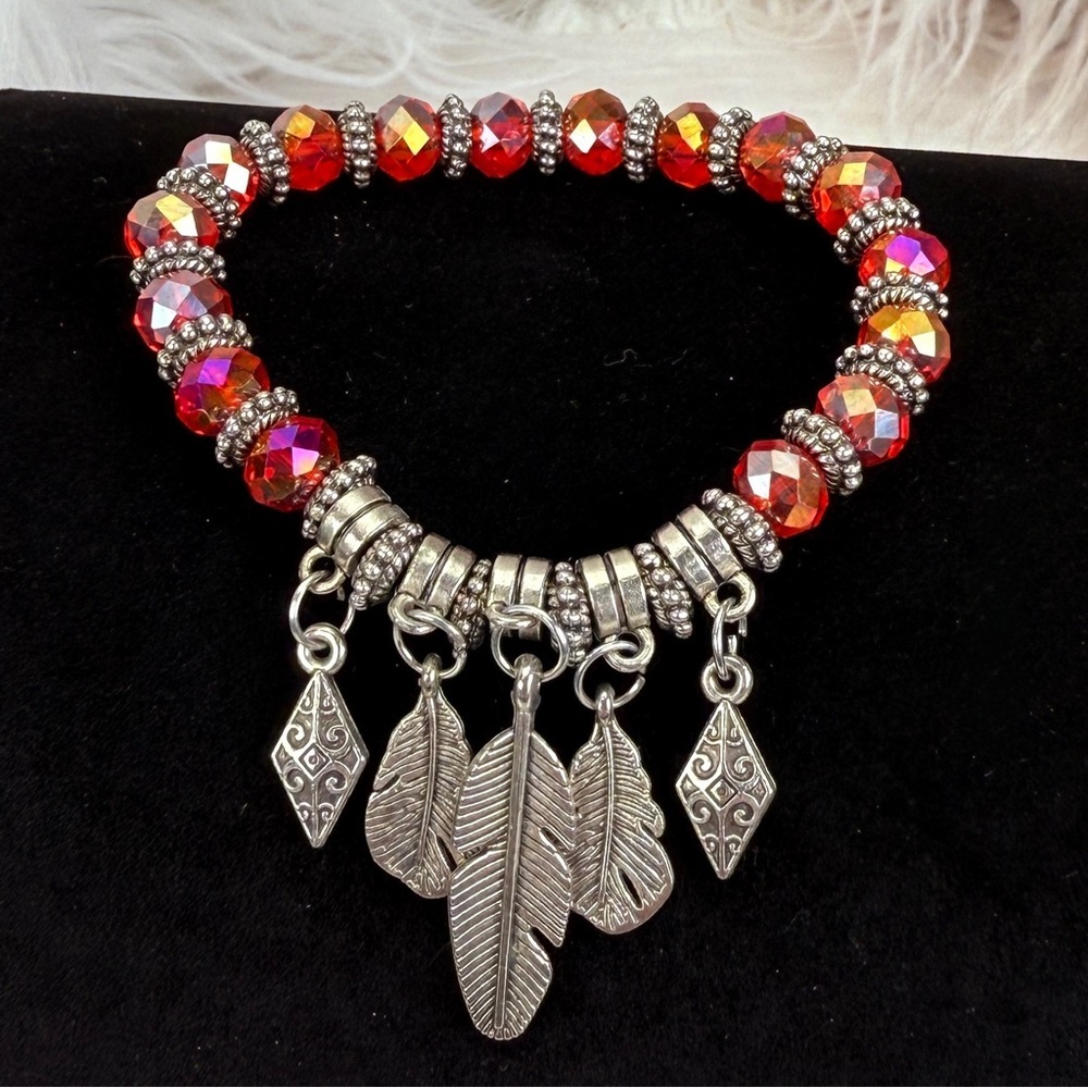 Pretty red and silver tone, reflective leaf charm costume stretch bracel…